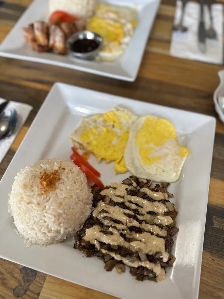 Couple Chef Restaurant signature Filipino dishes — chicken inasal and lechon kawali in Winnipeg